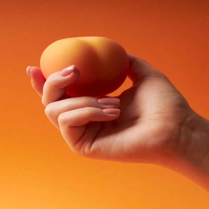 Womanizer Peach Toy stimulateur clitoridien